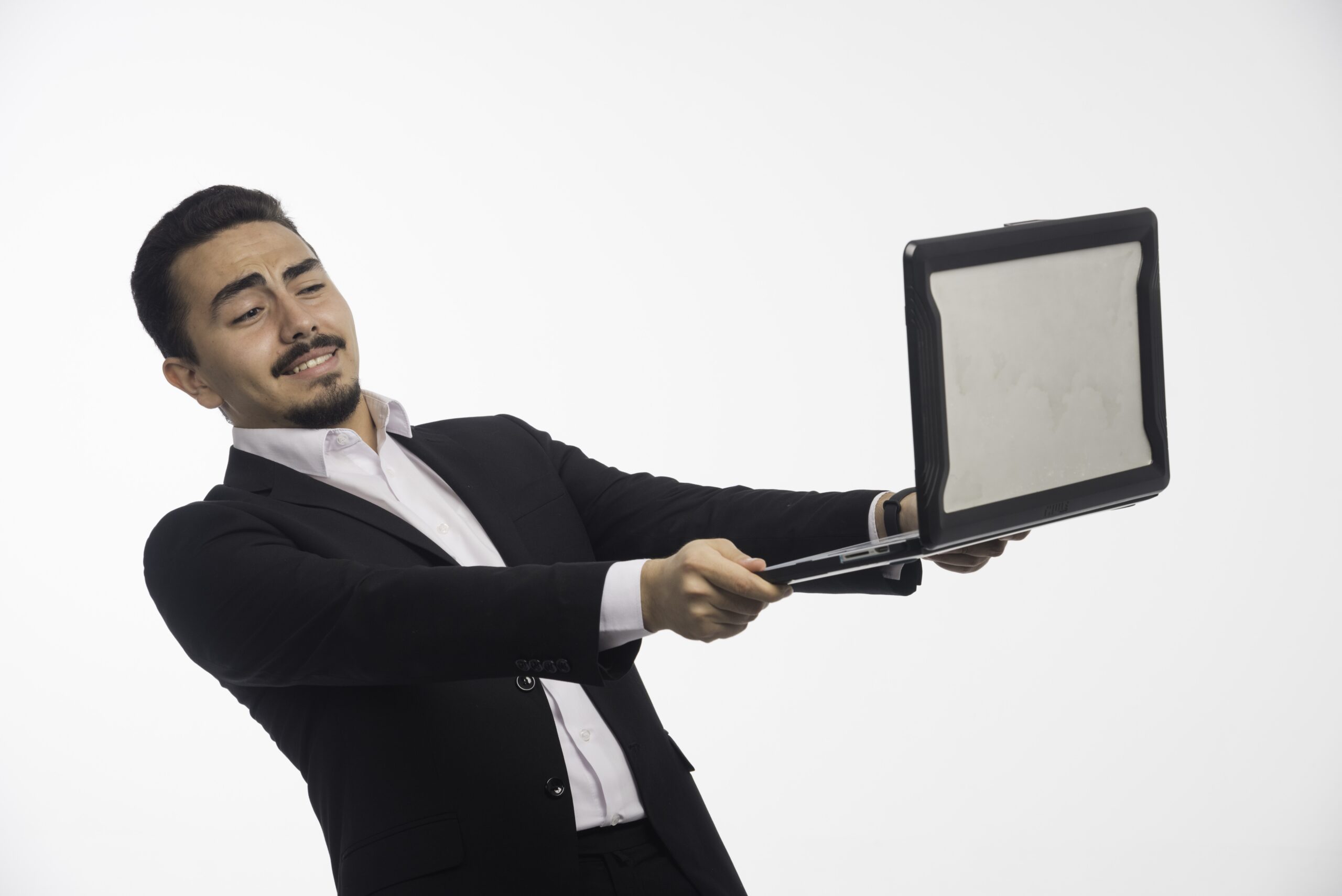 a businessman in dress code holding a laptop and having online meeting